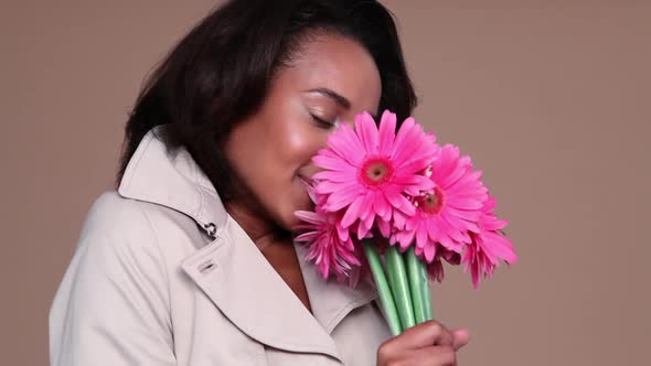 Happy young woman with pink flowers