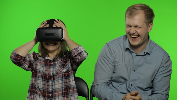 Man and Woman Using VR Headset Helmet To Play Game. Watching Virtual Reality 3D Video. Chroma Key