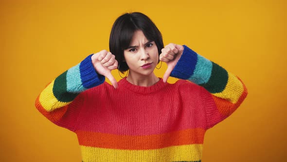 Young Displeased Woman Feeling Disgust Showing Thumbs Down Gesture with Both Hands Orange Studio