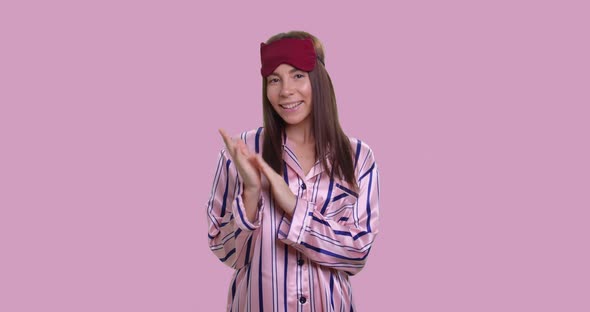 Woman in Pajamas Applaud with Ironic Smile Isolated Over Pink