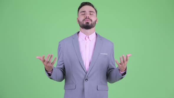 Happy Young Bearded Businessman Relaxing with Eyes Closed