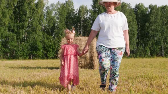 Grandparent Walks with Granddaughter in The Meadow