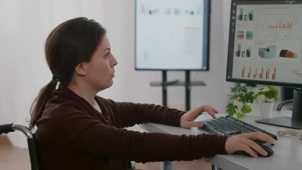 Paralysed Financial Expert Sitting in Wheelchair Analysing Economy Statistics