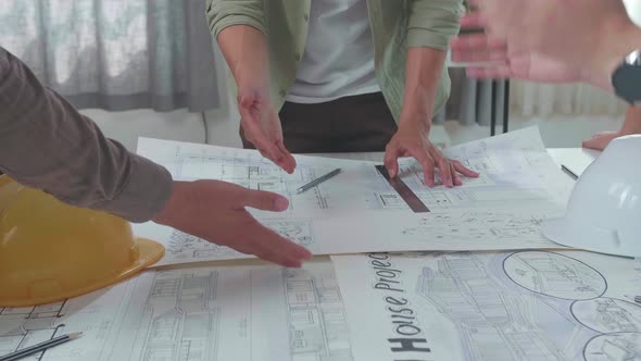 Close Up Of Group Of Asian Engineers Discuss About Building Construction At The Office