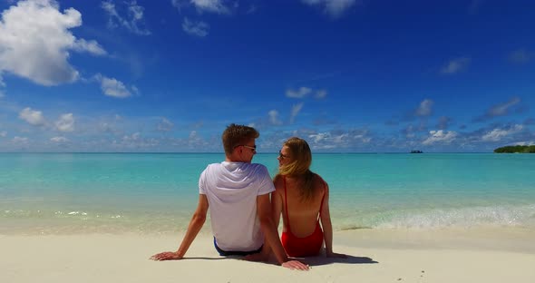 Romantic lady and man on romantic honeymoon enjoy life on beach on clean white sand background 