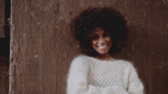 Smiling Young Model Leaning Against Wall In Woollen Dress