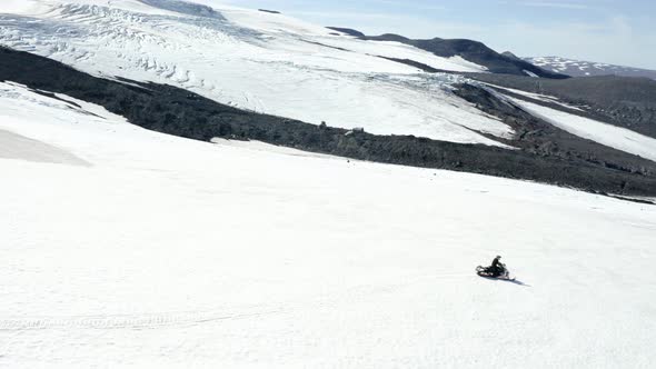 Snowmobile Sport Action on a Glacier in Iceland