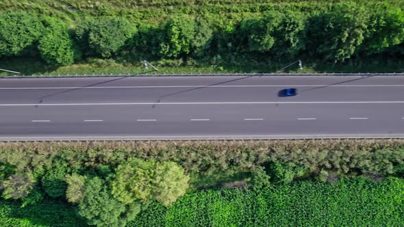 Car Riding on the Highway Through the Forest on Countryside