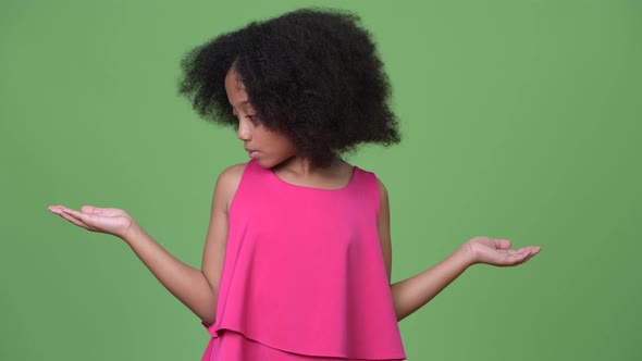 Young Cute African Girl with Afro Hair Choosing Between Left and Right