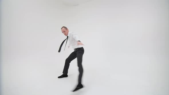 Office Clerk Dancing Bottom Break on a White Background. A Happy Businessman Is Dancing a Break