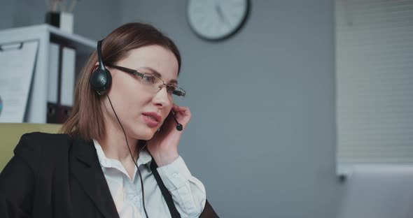 Business Woman Receptionist Wear Headphone Video Conference Calling on Laptop Computer