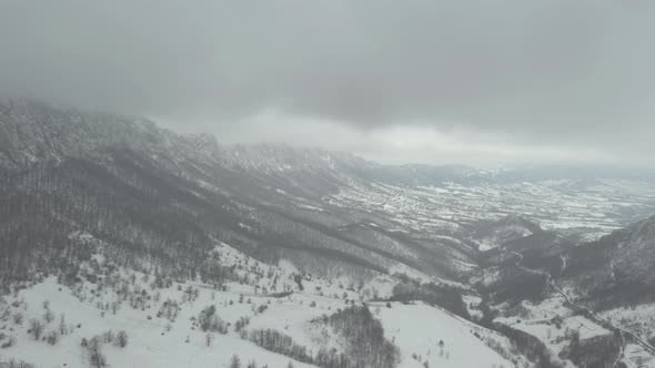 Snowing on mountain ranges of Velik Krs 4K drone video