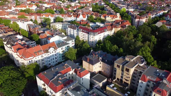 An apartment building is renovated and refurbished.Buttery soft aerial view flight tilt down drone