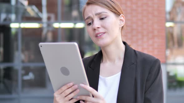 Outdoor young Businesswoman Upset by Loss on Tablet