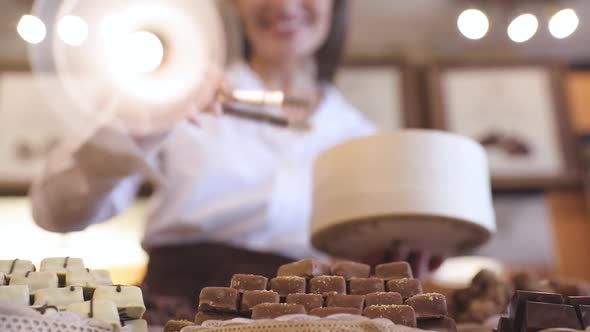 Chocolate Store. Female Seller In Confectionery Shop