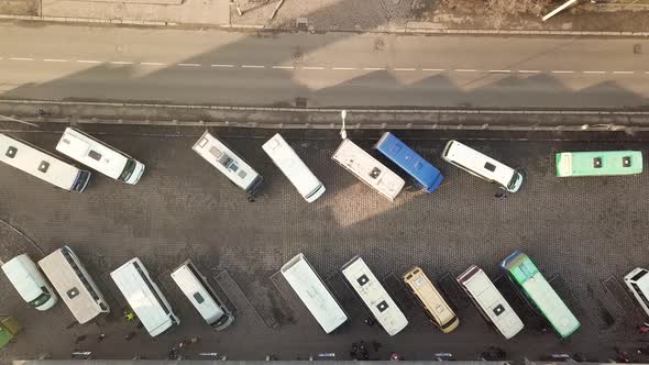 Aerial footage of many buses moving on a busy city street.
