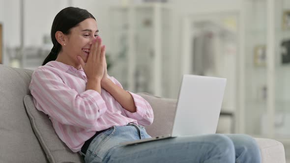 Excited Young Latin Woman Celebrating Success on Laptop at Home 