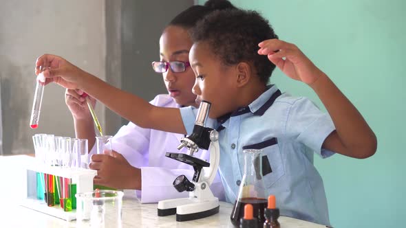 Two African American Mixed Kids Testing Chemistry Lab Experiment