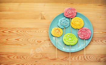 Colorful lollipops and different colored round candy