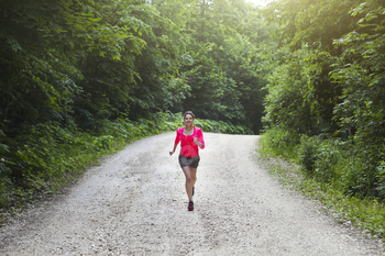 Young fitness woman runner athlete running at road