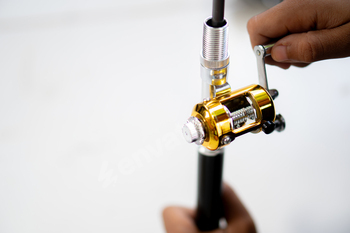 Adjusting a fishing reel on a fishing rod