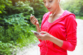 Young lady runner on a rural road in the morning