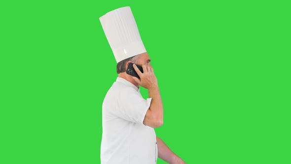 Chef Speaking on the Phone While Walking on a Green Screen Chroma Key