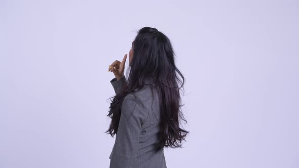 Rear View of Young Beautiful Persian Businesswoman Directing and Pointing Finger