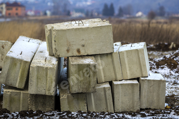 Stack of concrete blocks for foundation on construction site.