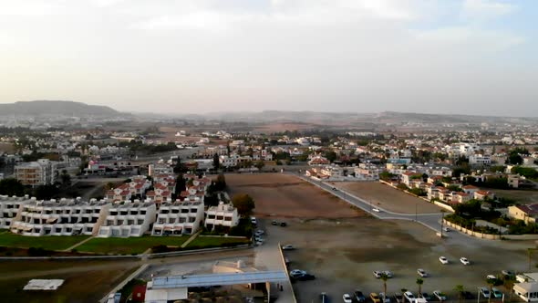 View of Larnaca Greece coastline during daytime, descending aerial panning left