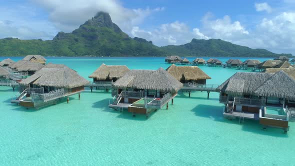 Aerial drone view of a luxury resort and overwater bungalows in Bora Bora tropical island