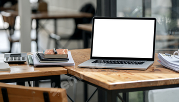 Laptop with blank screen on table.