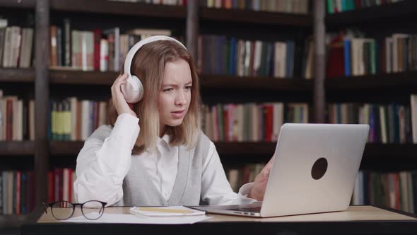 Focused Teen Girl Caucasian Young Woman School Wear Headphones Learn Watching Online Webinar Webcast