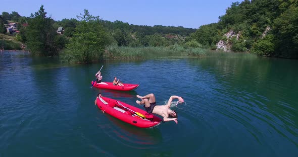 Man doing backflip from a canoe on Mreznica river, Croatia