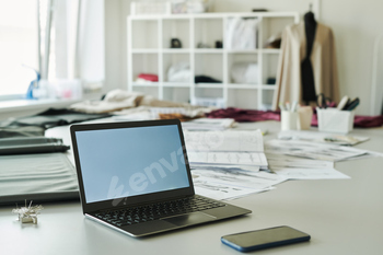 Laptop with blank screen in atelier