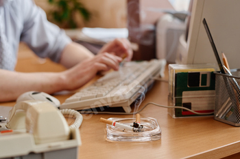 Typing on Keyboard with Ashtray on Desk