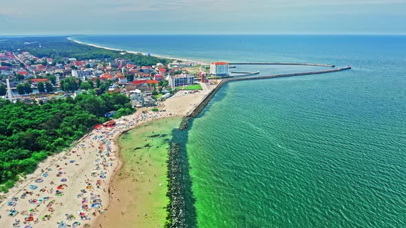 Beach with people on Baltic Sea in Darlowko, aerial view