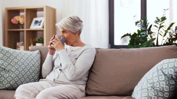 Adult Son and Senior Mother with Photo at Home