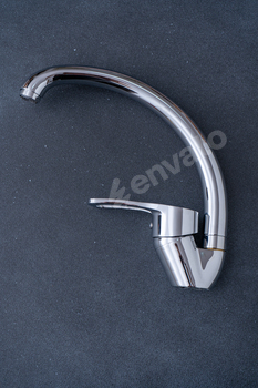 Chrome-plated mixer tap for water in the bathroom and kitchen. Plumbing.