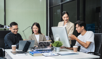 Business team working on a project in the office or reviewing and discussing a business project.