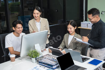 Business team working on a project in the office or reviewing and discussing a business project.