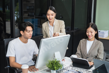 Business team working on a project in the office or reviewing and discussing a business project.