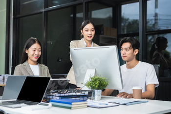 Business team working on a project in the office or reviewing and discussing a business project.