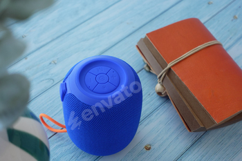 smart speaker clock and notebook on table