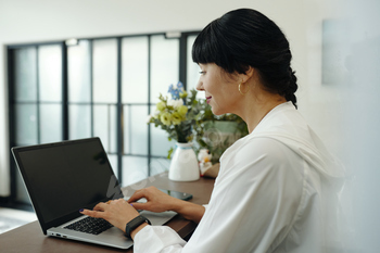 Woman Registrating Clients Online On Laptop