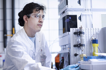 Focused scientist adjusting equipment in a modern lab