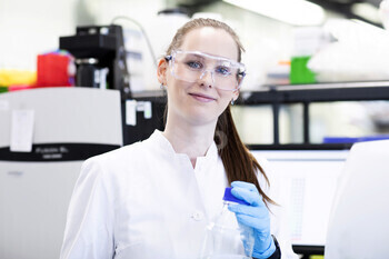 Confident scientist working in a lab with equipment