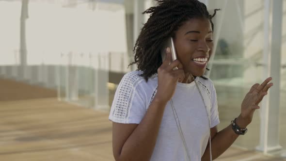 Excited African American Woman Talking on Smartphone