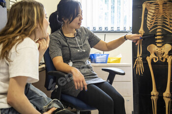 Medical professional explaining anatomy to a patient in a medical practice