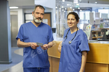 Medical professionals standing at the reception of a medical practice in the UK